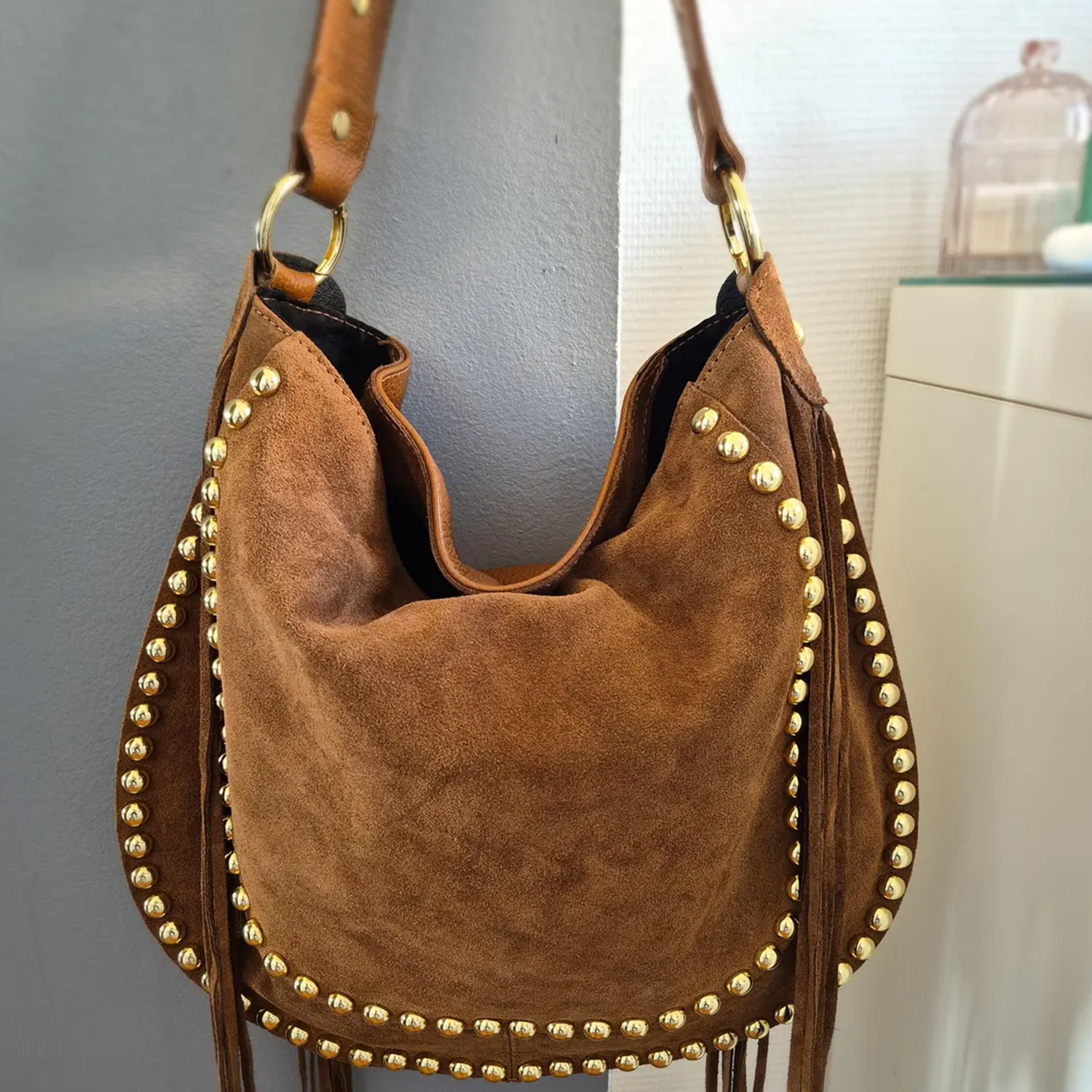Camel Brown Slouch Crescent Shoulder Bag With Perimeter Gold Stud Trim, Long Side Fringe Tassels, Adjustable Wide Shoulder Strap And Chunky Metal Ring Hardware