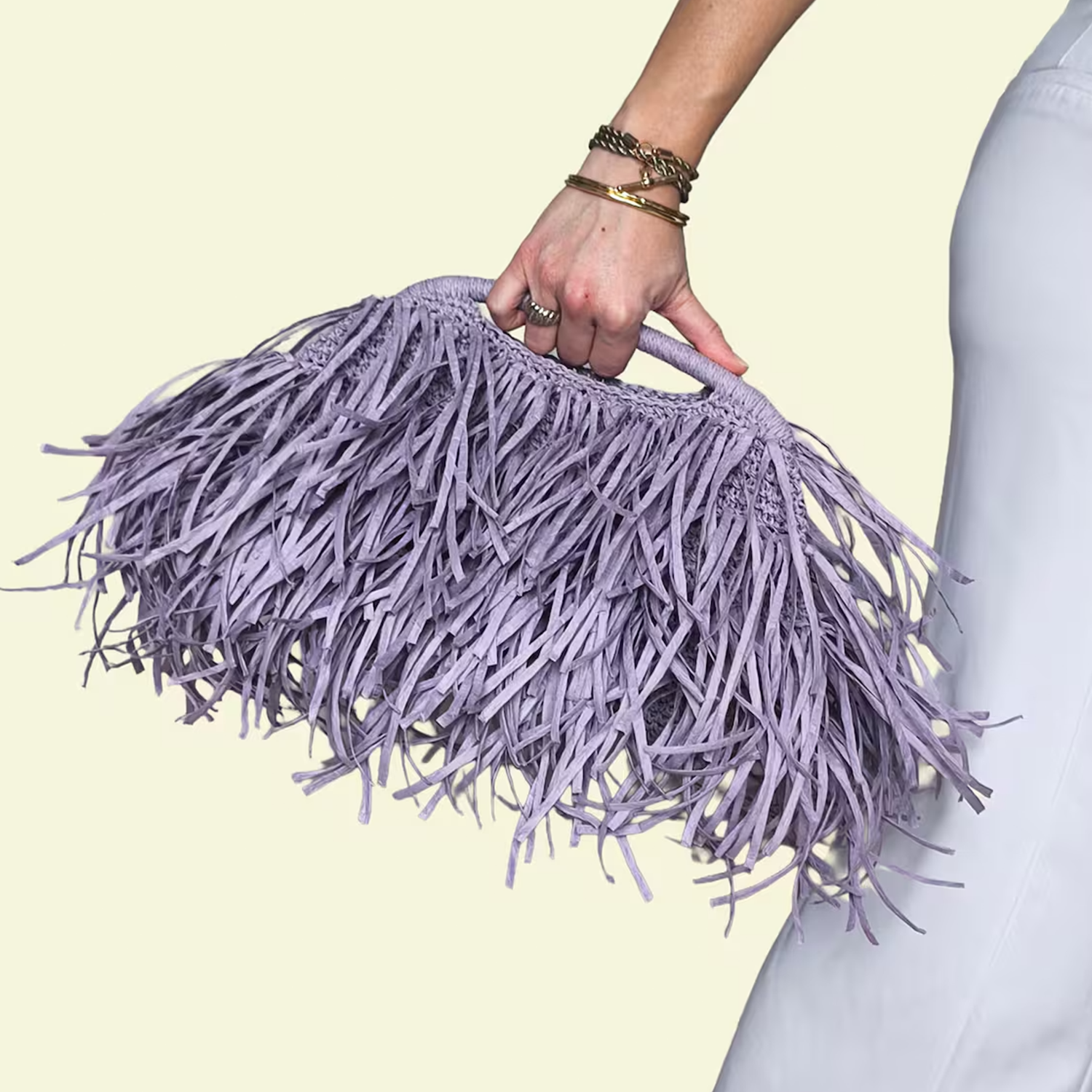 Soft Lavender Multi-Layer Fringe Handheld Clutch With Circular Woven Top Grip, Tight Interlaced Base Frame And Flowing Textured Outer Trim