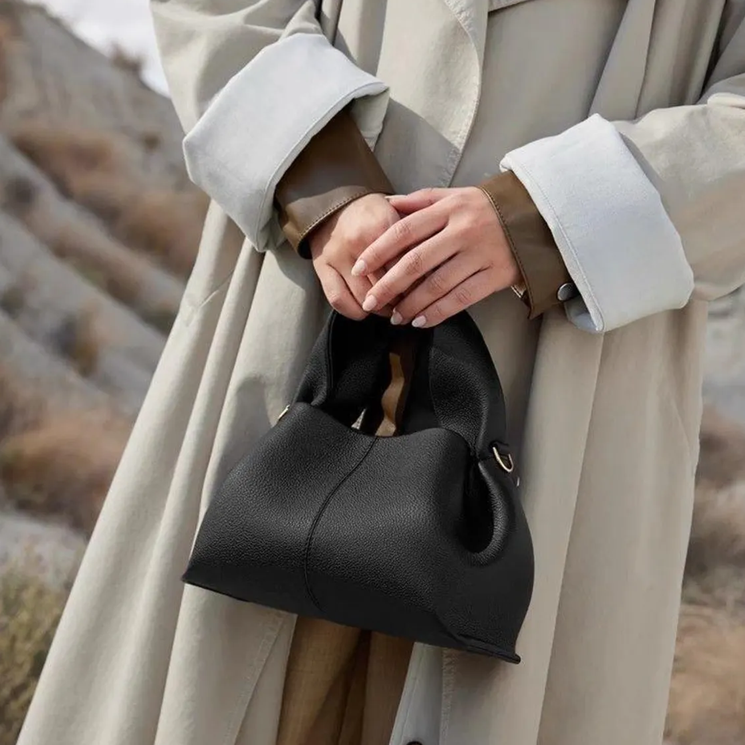 Soft Fold Side Mini Bucket Handbag With Integrated Loop Top Grip, Side Metal Ring Fittings And Central Vertical Seam Detailing