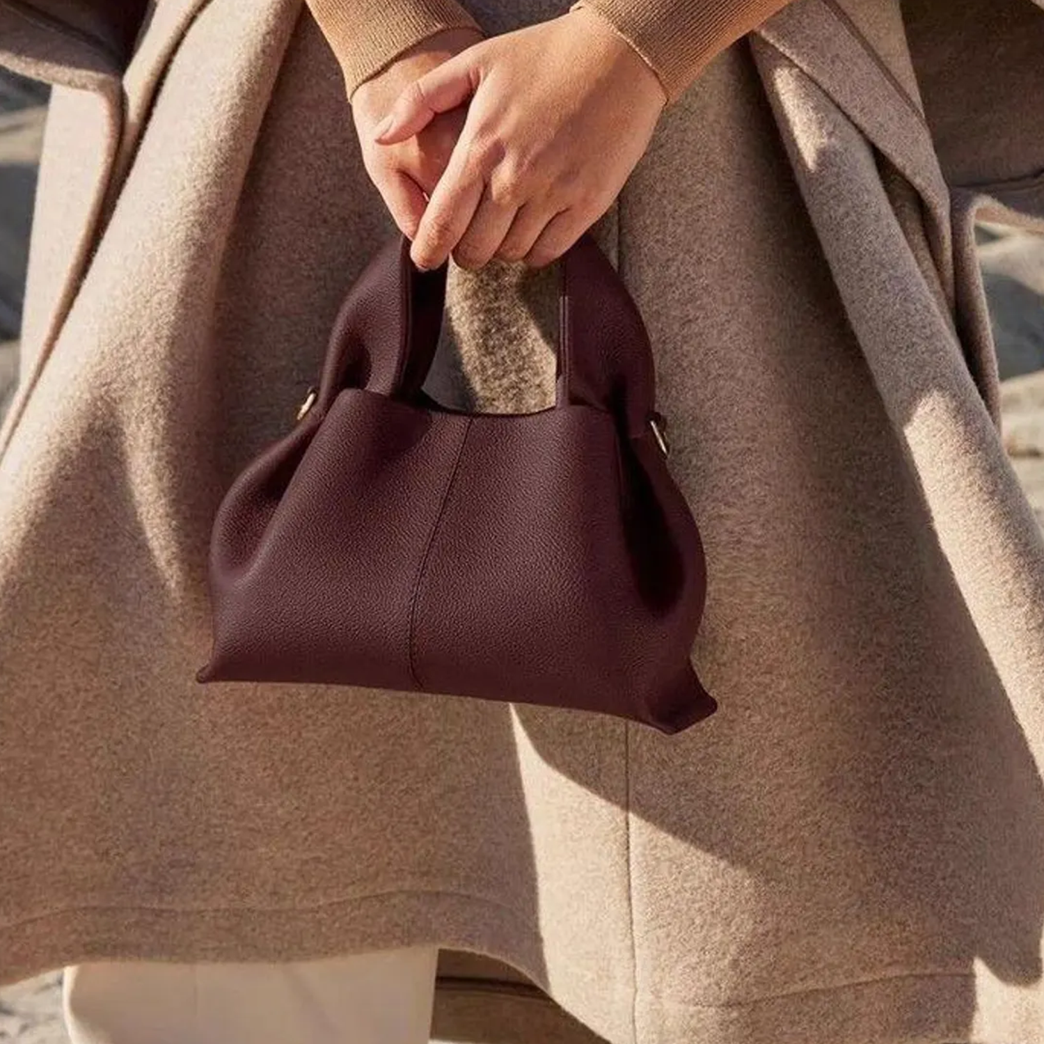 Soft Fold Side Mini Bucket Handbag With Integrated Loop Top Grip, Side Metal Ring Fittings And Central Vertical Seam Detailing