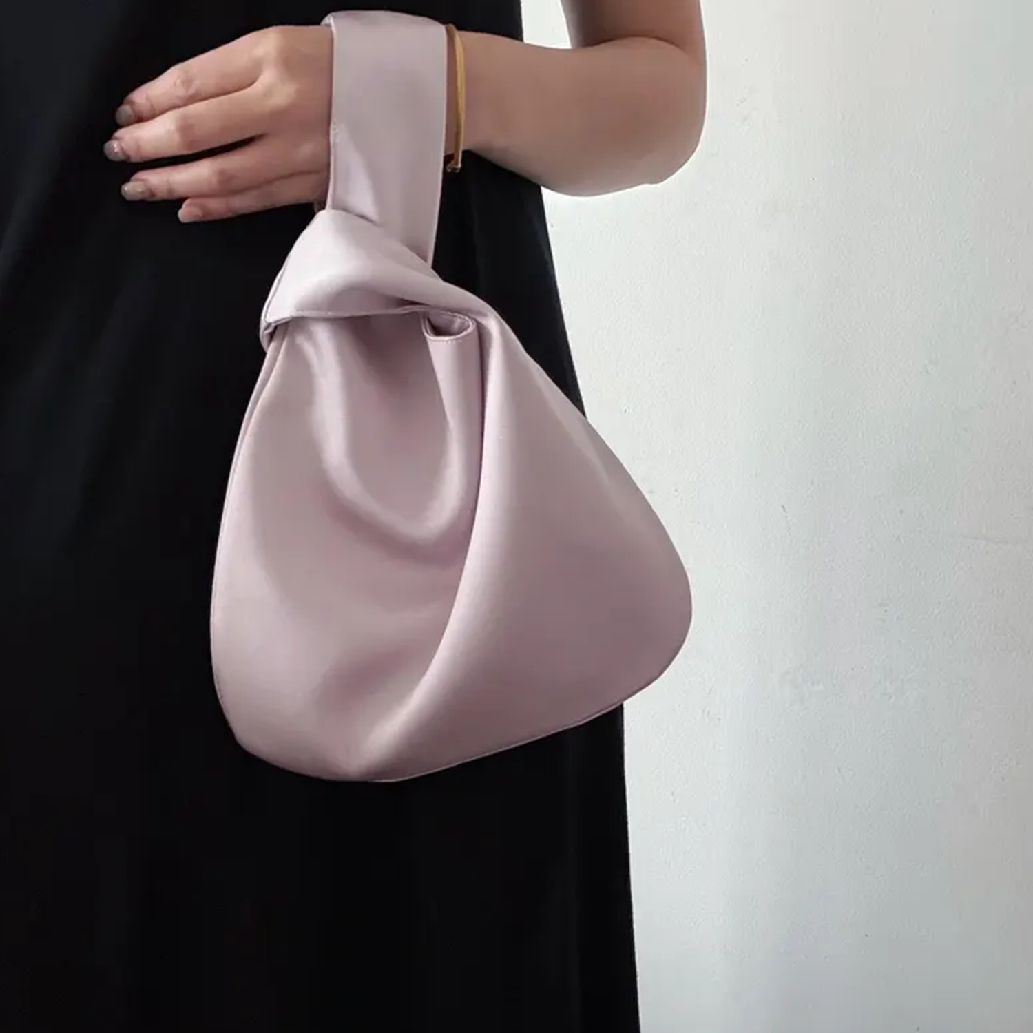 Lustrous Teardrop Knot Wrist Pouch With Interwoven Loop Strap Construction, Seamless Single Interior Cavity And Hardware-Free Minimalist Silhouette