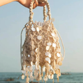 Off-White Diamond Mesh Woven Bucket Tote With Dangling Round Disc Embellishments, Braided Loop Top Handles And Drawstring Lined Interior Cavity